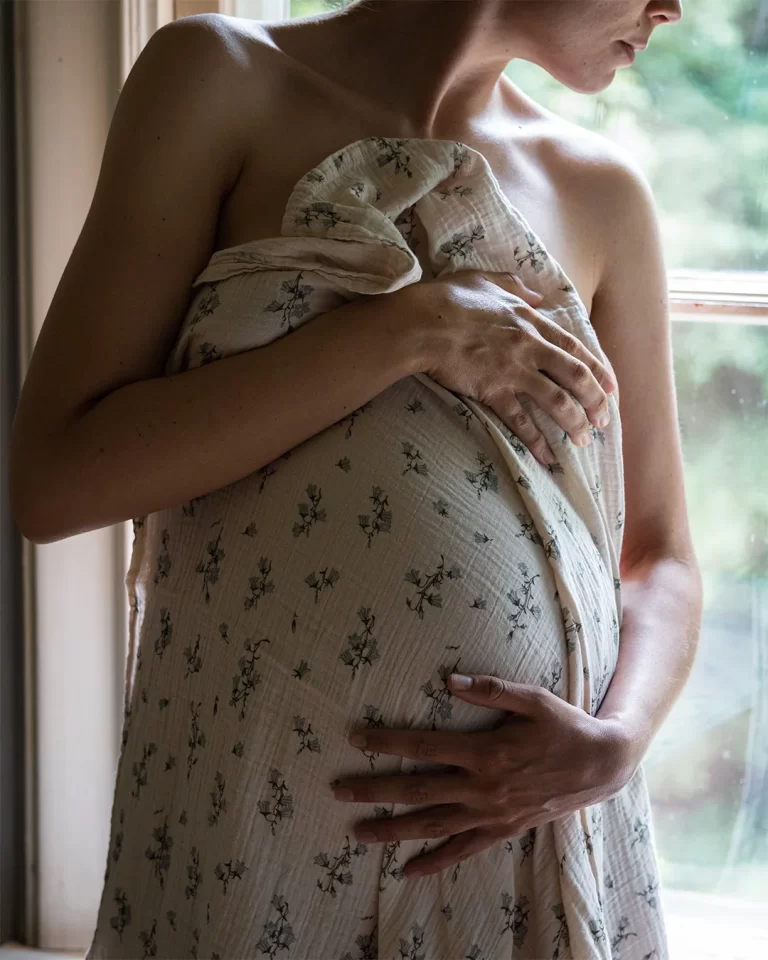 Pregnant Woman Wrapped in a Flowery Blanket