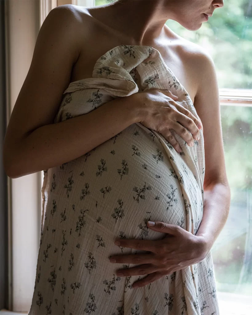 Pregnant Woman Wrapped in a Flowery Blanket